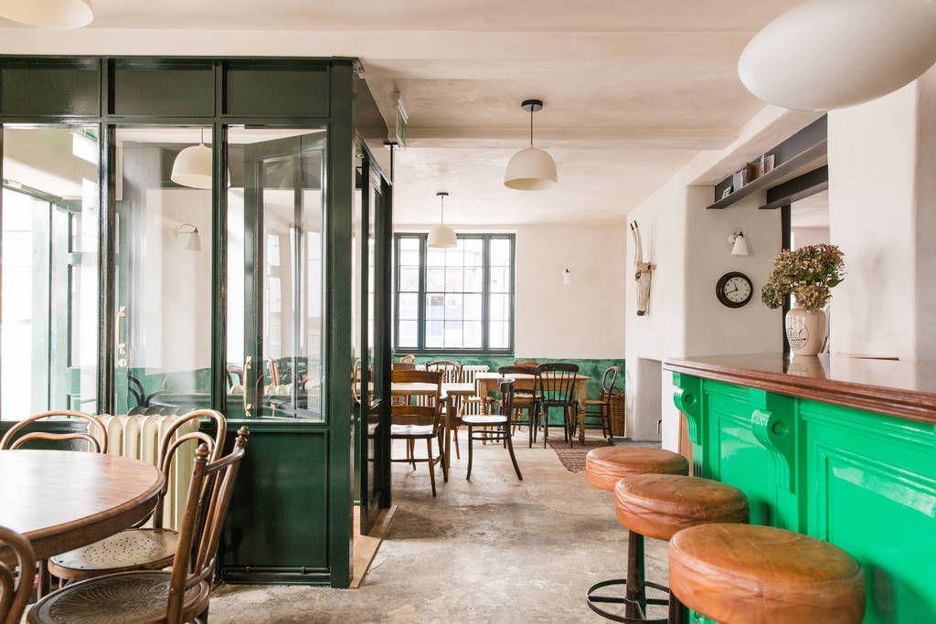 Interior of a pub with a green door and bar