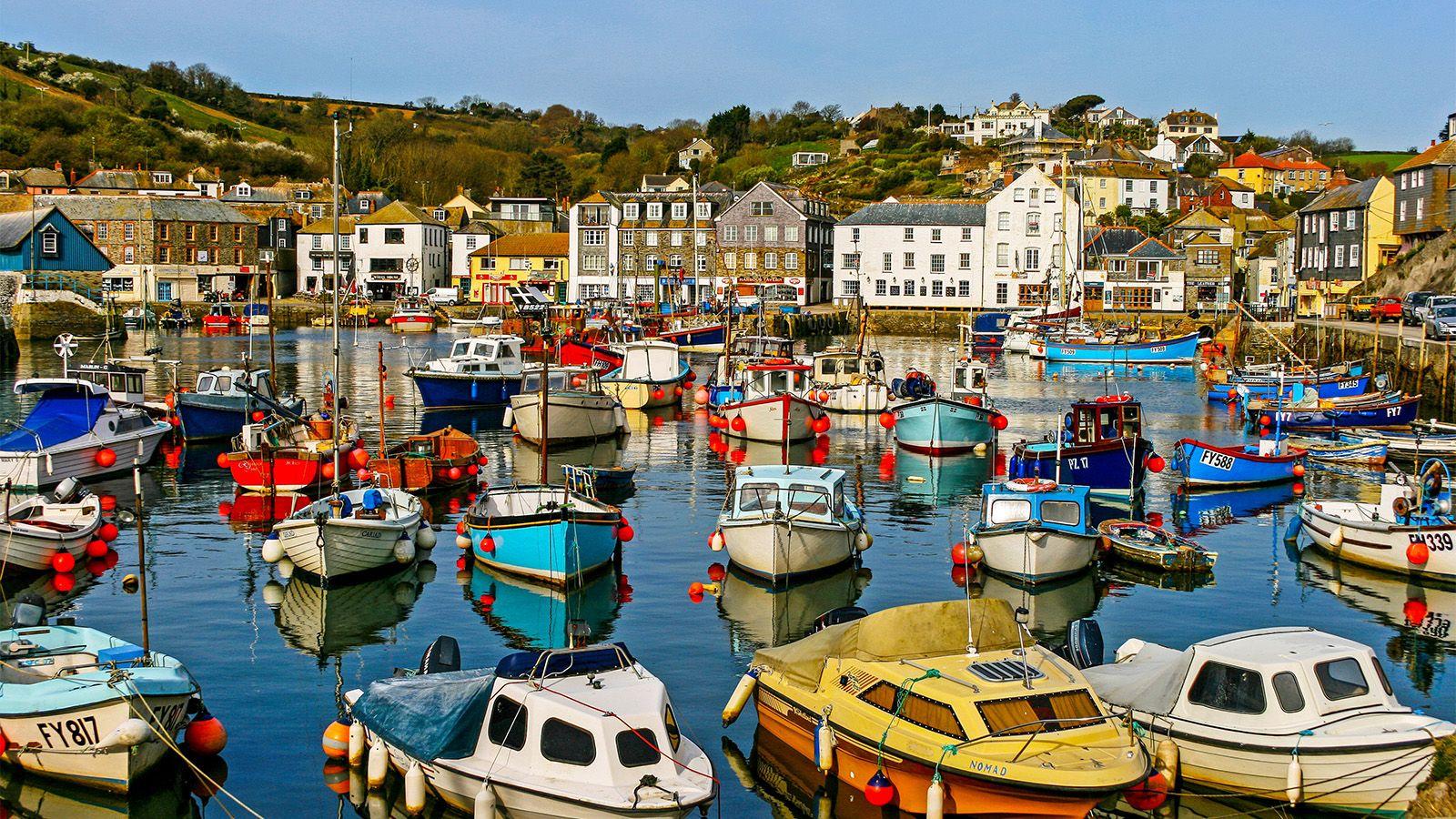 A brightly coloured view of St Austell with boats and buildings